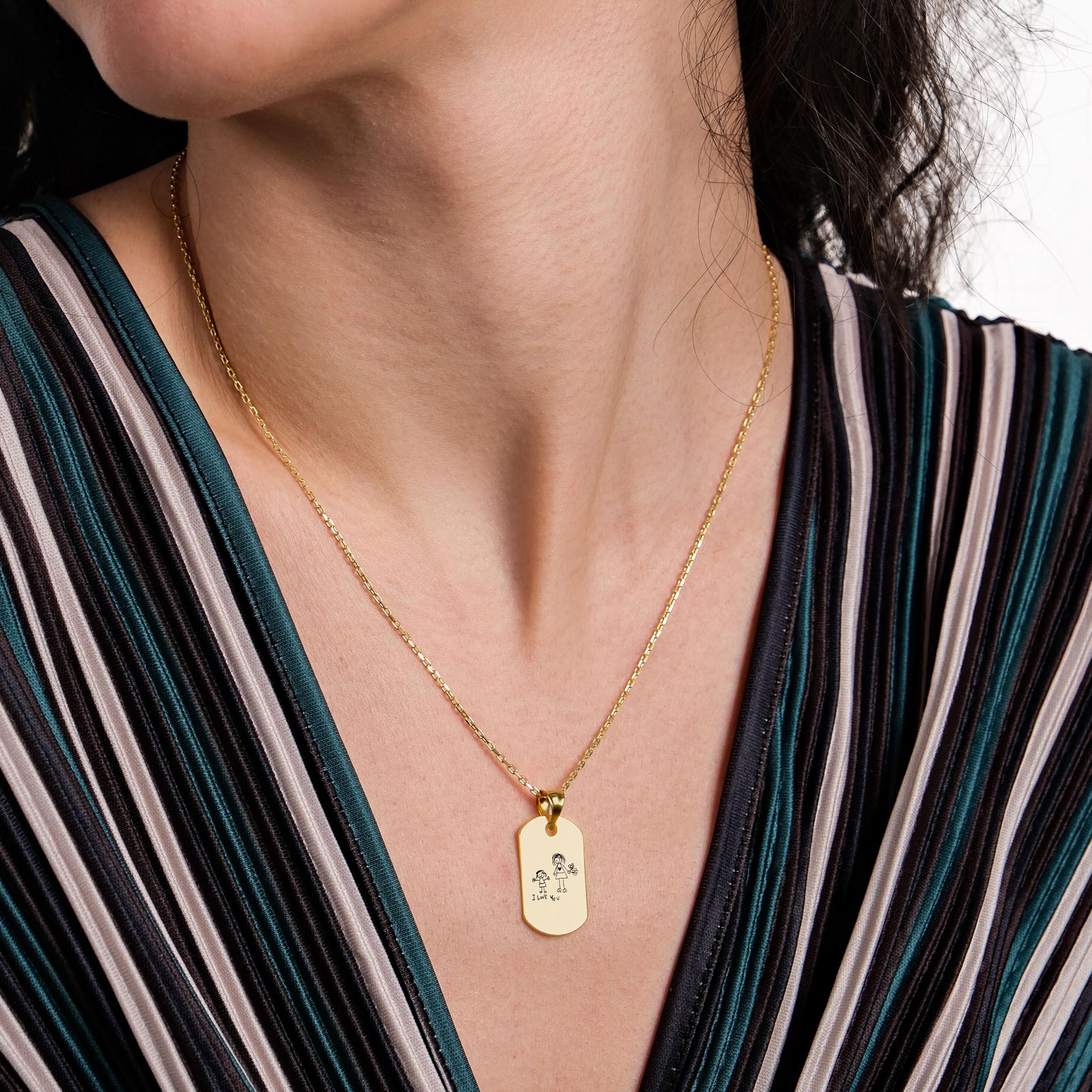 Elegant 18K gold vermeil handwriting necklace styled on a woman wearing a striped v-neck dress, highlighting the engraved pendant.