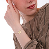14K solid gold Kids Handwriting Bracelet seen clearly as the model touches her face.