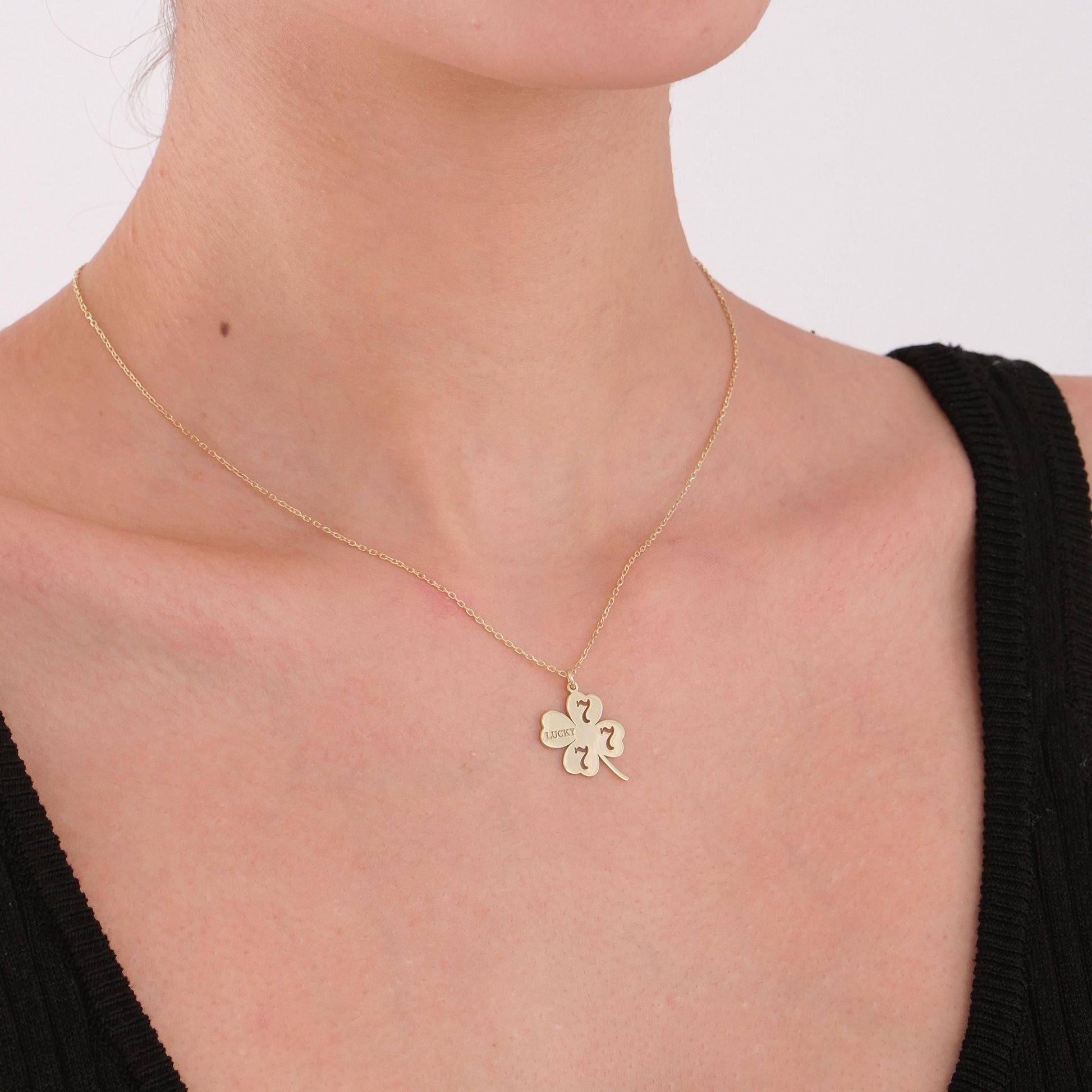 Minimalist gold necklace adds a touch of charm and luck to everyday outfits.