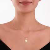 Centered on the chest, this personalized family necklace features a minimal gold boy figure.