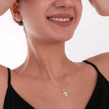 A smiling model showcases the family name necklace in a timeless and meaningful style.