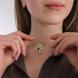 Woman gazing upward while wearing a 14K solid gold engraving photo necklace with a custom photo pendant.