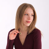Woman wearing a 14K solid gold fingerprint necklace with a burgundy ribbed top.