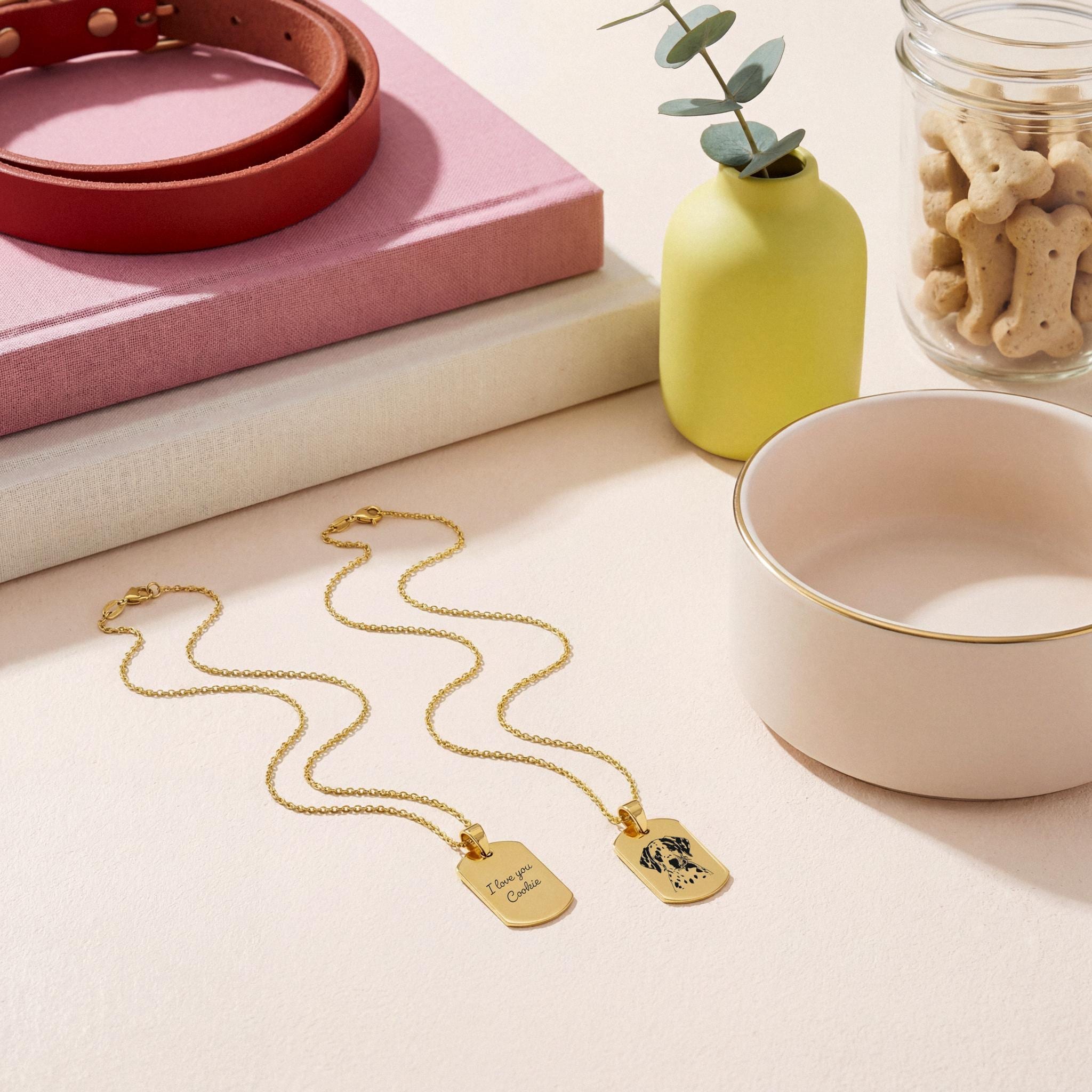 Two 18K Gold Vermeil Pet Photo Necklace pendants featuring a custom pet portrait and engraved message, displayed on a neutral surface.