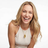 Portrait of a smiling woman wearing an 18K Gold Vermeil Custom Picture Necklace with custom engraved family image on a gold dog tag pendant