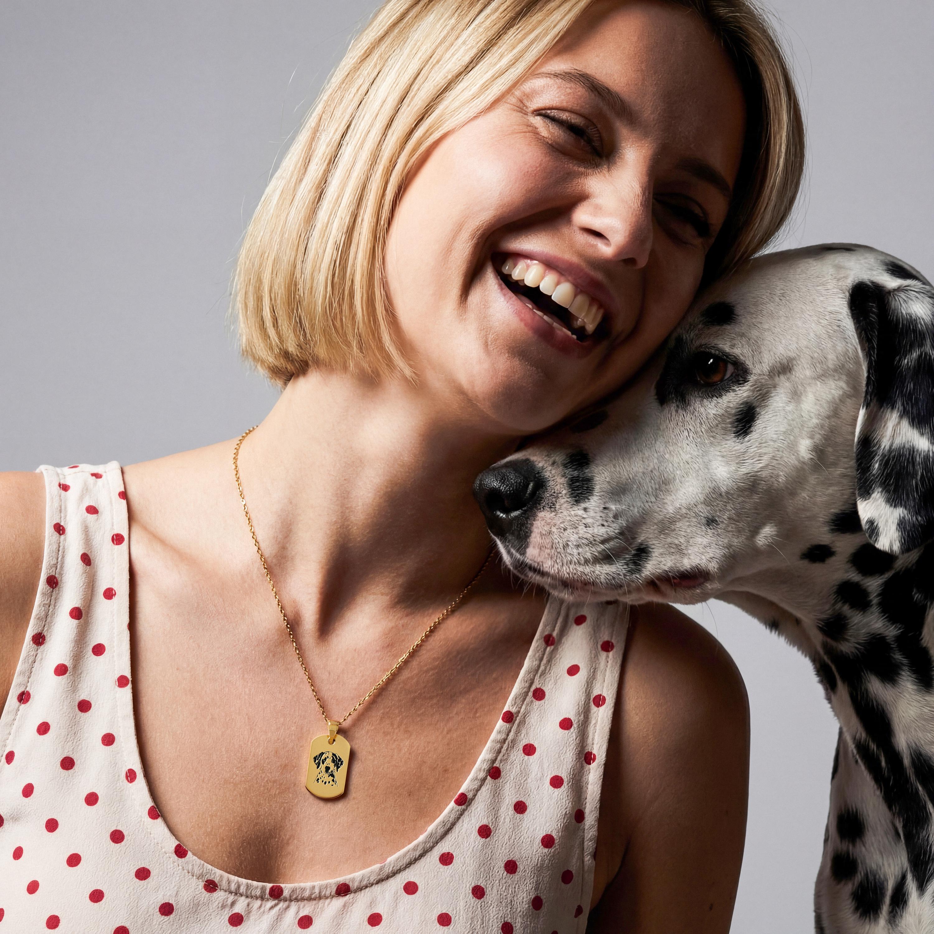 Woman cuddling her dog while wearing an 18K Gold Vermeil Pet Photo Necklace with a custom engraved pet portrait.