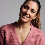 18K Gold Vermeil Personalized Medical ID Necklace worn by a smiling woman, featuring engraved caduceus symbol on gold dog tag pendant.