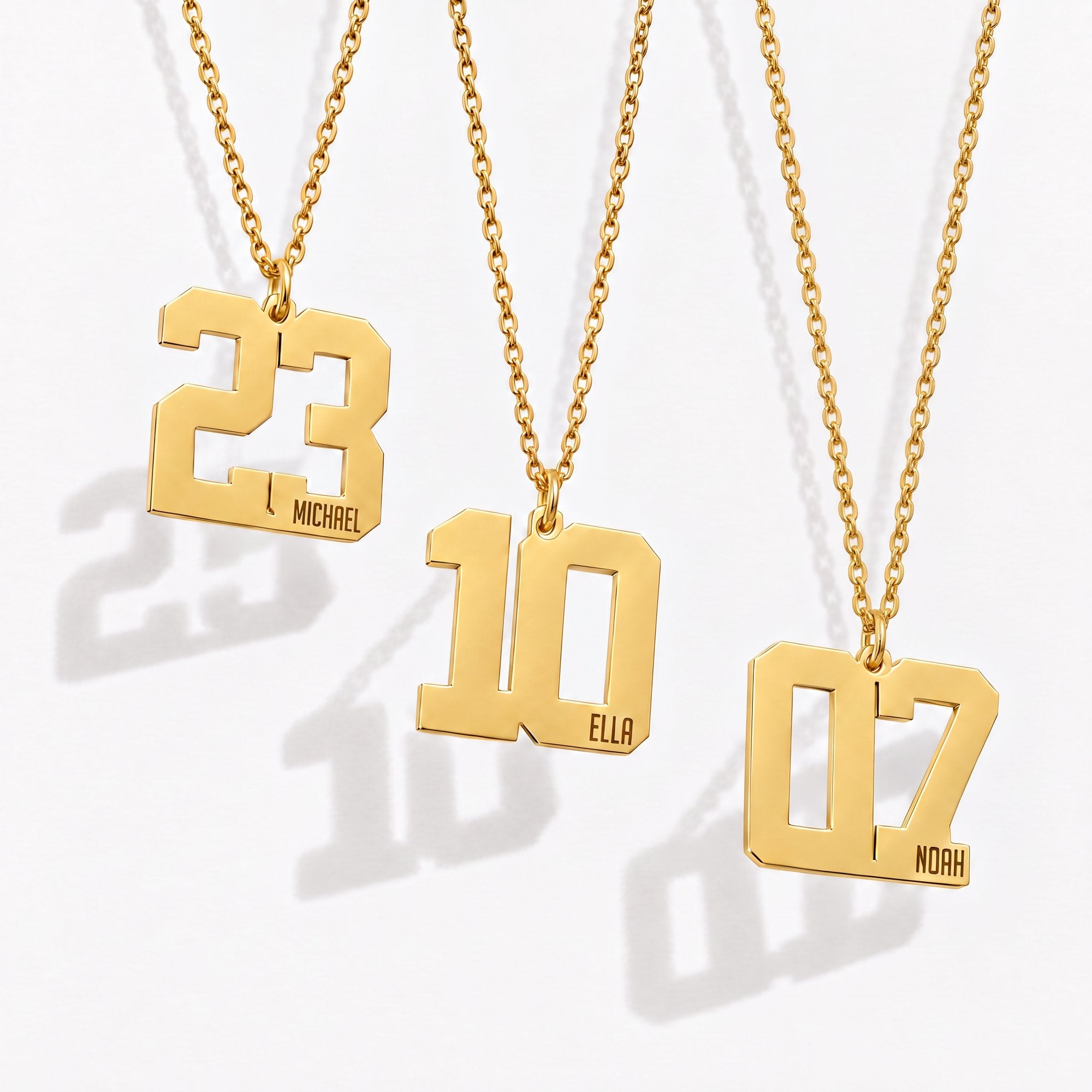 Gold jersey number necklace with name engraved on the number pendant