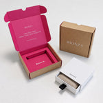 MIONZA gift packaging: kraft mailer box with pink interior and a white drawer box with a jewelry pouch