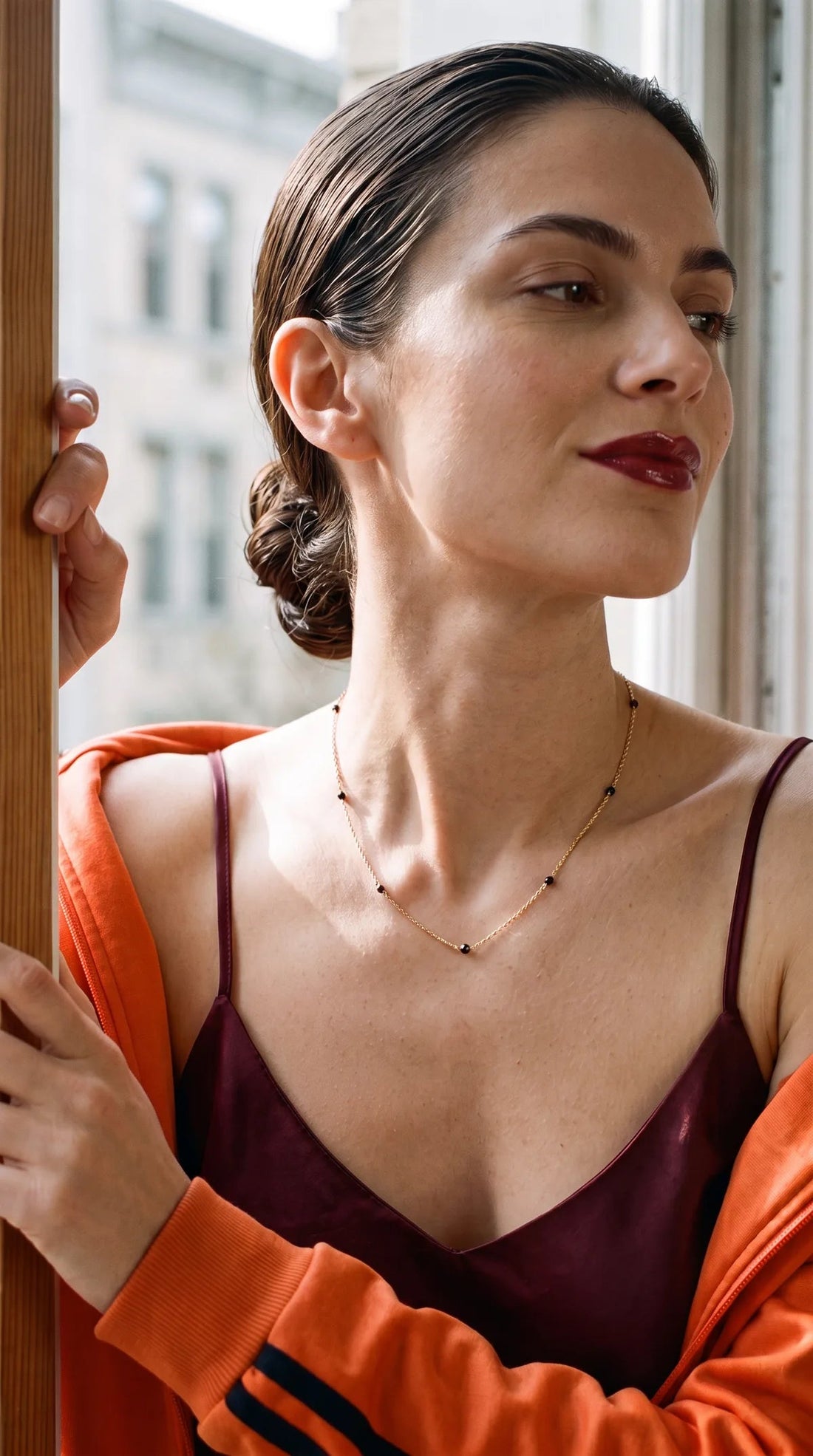 Black onyx necklace worn with an orange jacket