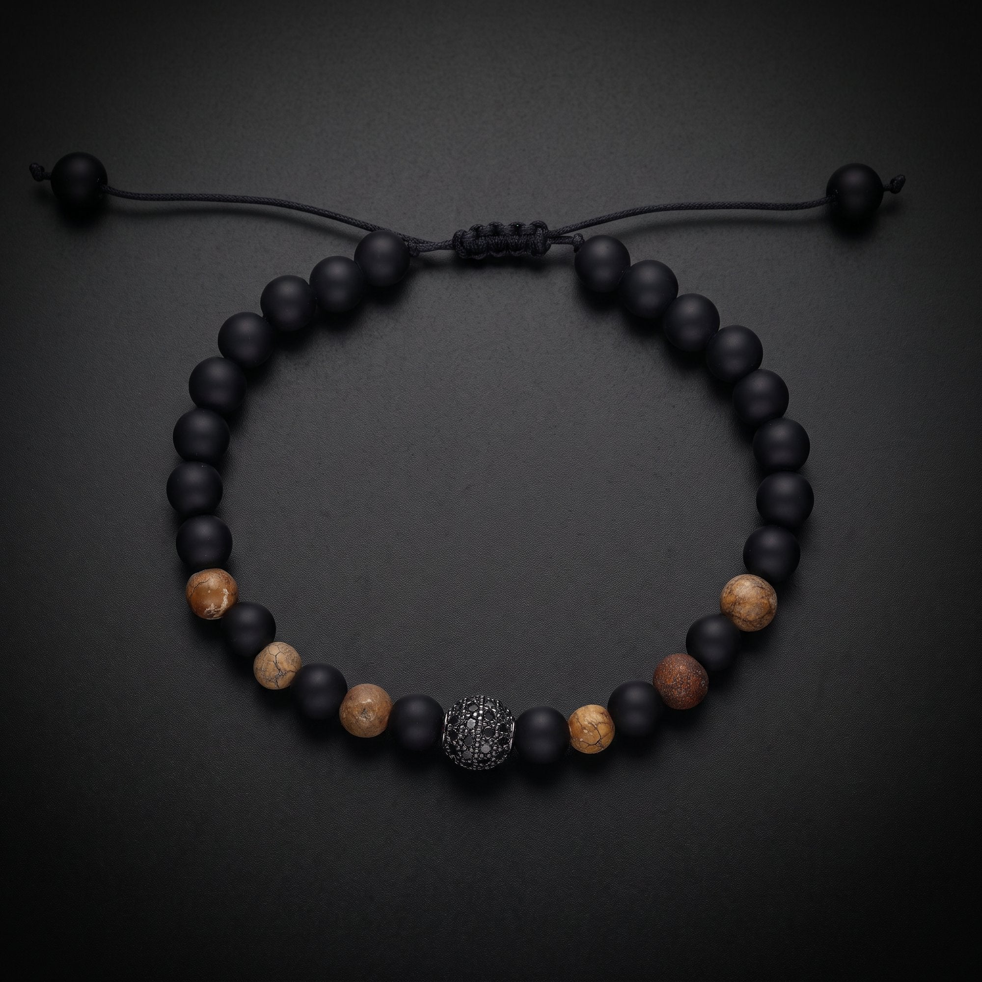 Men's natural stone bracelet with matte onyx, tiger's eye and a pavé bead on an adjustable cord