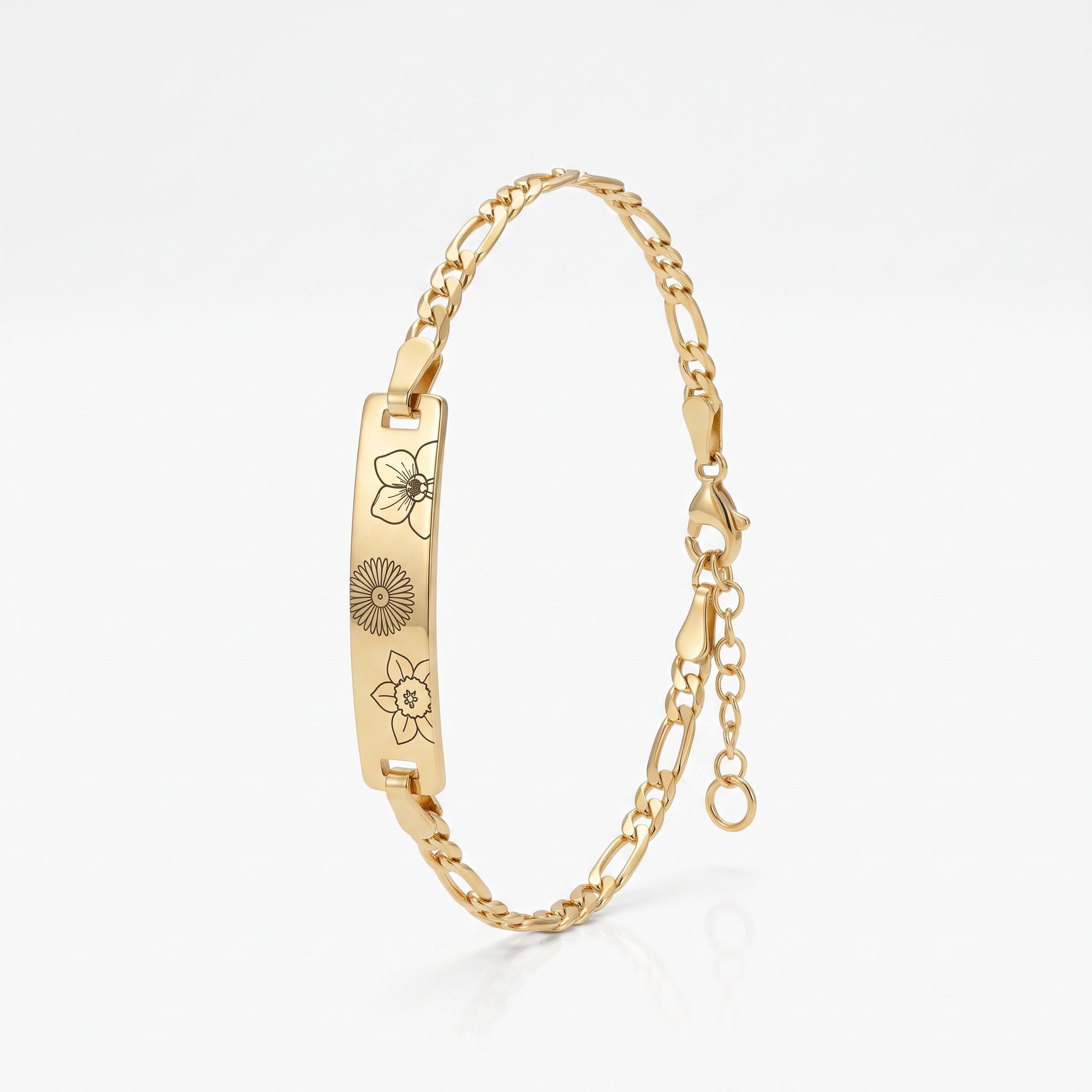 Personalized birth flower bracelet in gold, a bar engraved with family birth month flowers on a figaro chain, a mothers bracelet