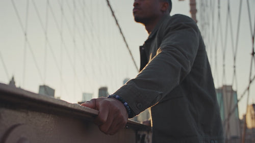Man on the Brooklyn Bridge at sunrise wearing a MIONZA Men sodalite bead bracelet