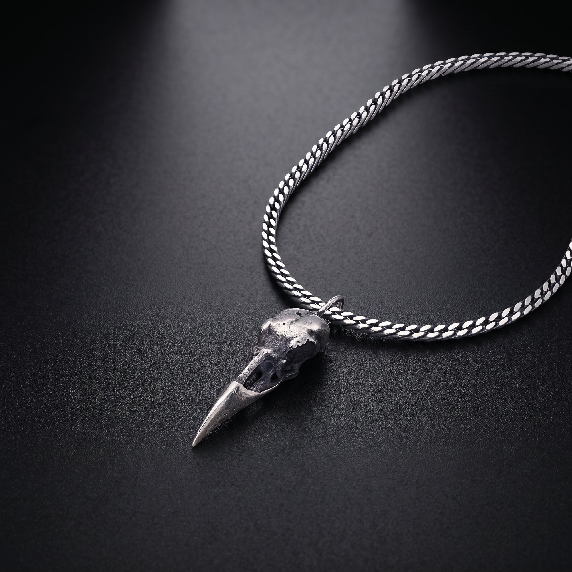 Men's raven skull necklace in oxidized sterling silver on a curb chain