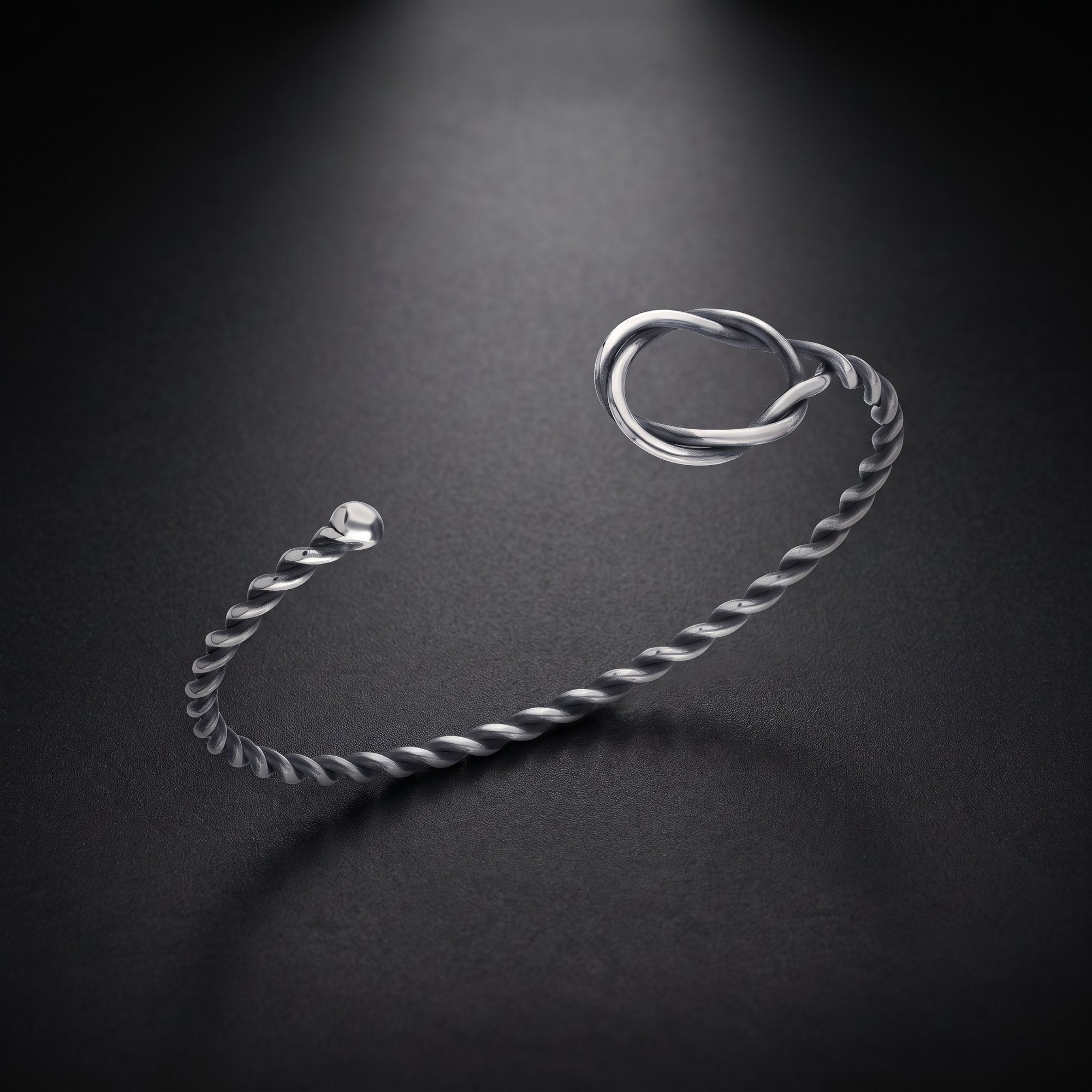 Men's twisted rope cuff bracelet in sterling silver with a love knot
