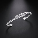 Men's twisted wire cuff bracelet in sterling silver with a knot design