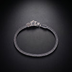 Men's wolf head bracelet with an ornate clasp in oxidized 925 sterling silver and a braided band