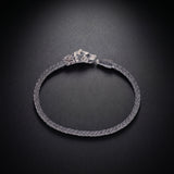 Men's wolf head bracelet with an ornate clasp in oxidized 925 sterling silver and a braided band