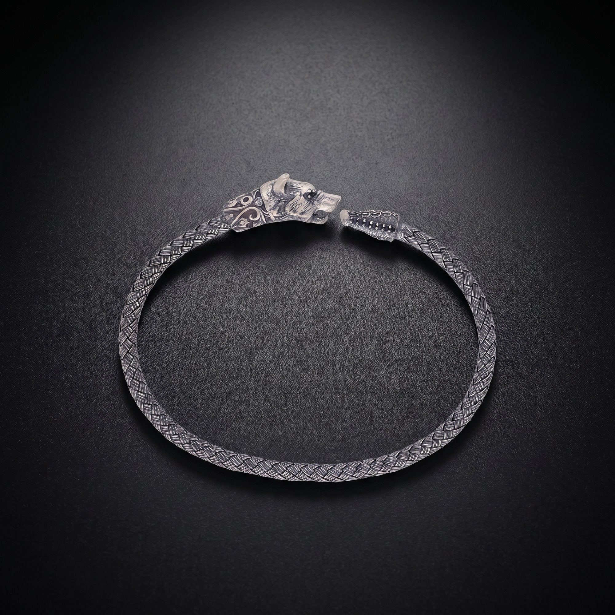 Men's wolf head bracelet with an ornate clasp in oxidized 925 sterling silver and a braided band